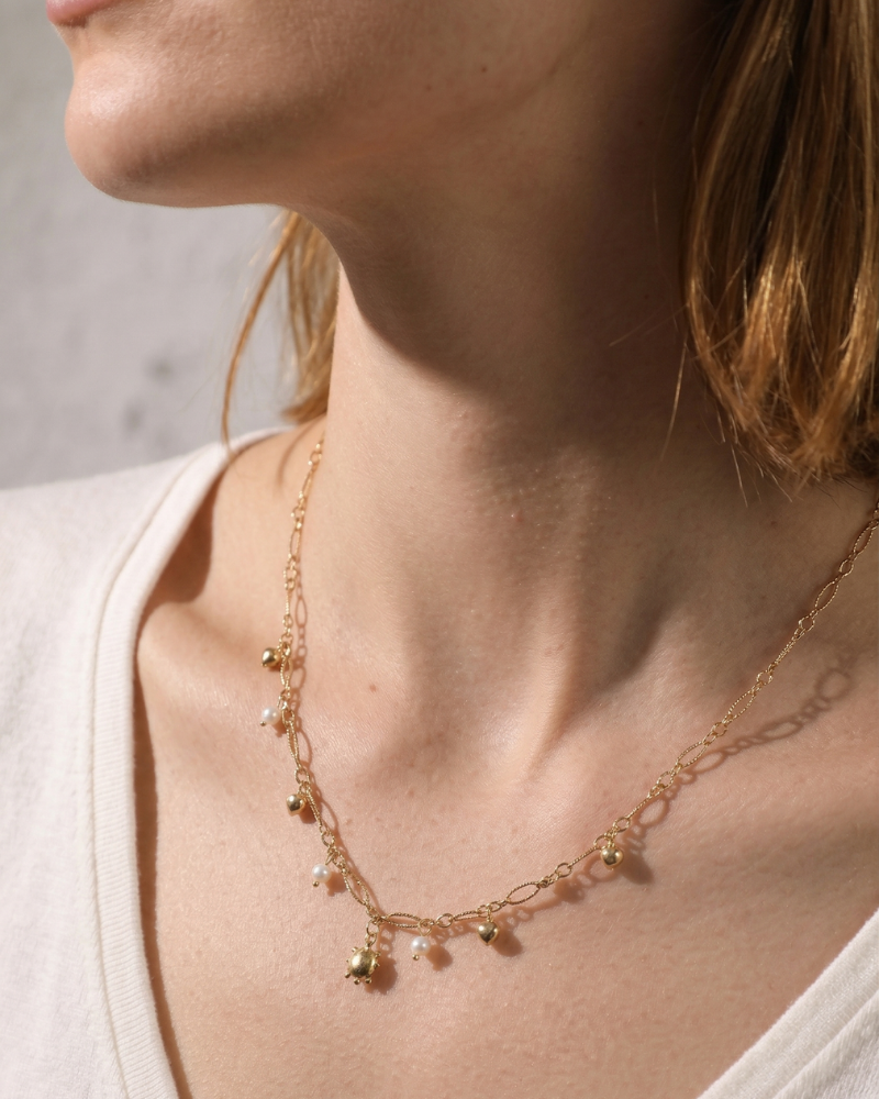 Celestial sun and star necklace worn on model