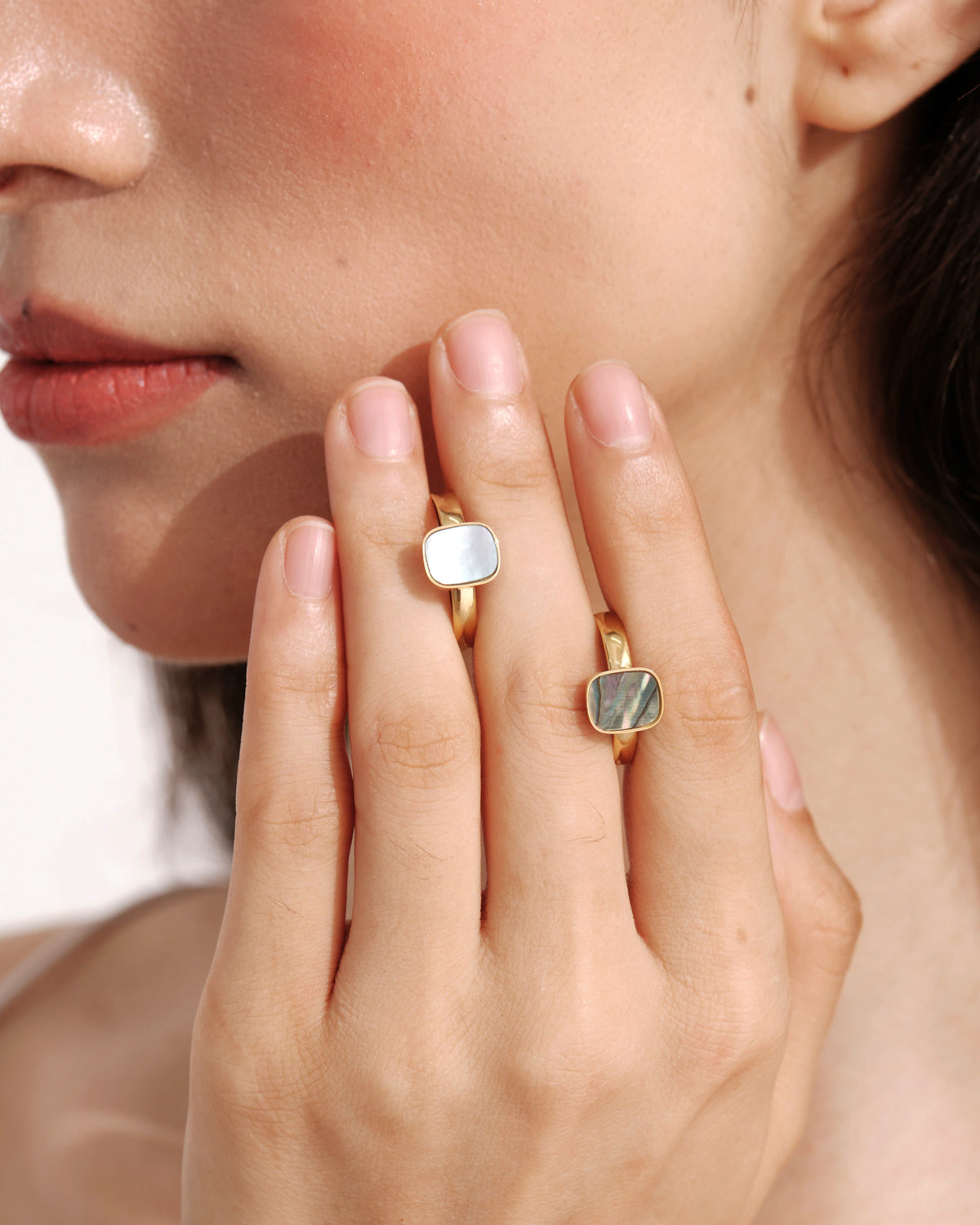 Model wearing two Tidal Stone Rings with iridescent shell inlays