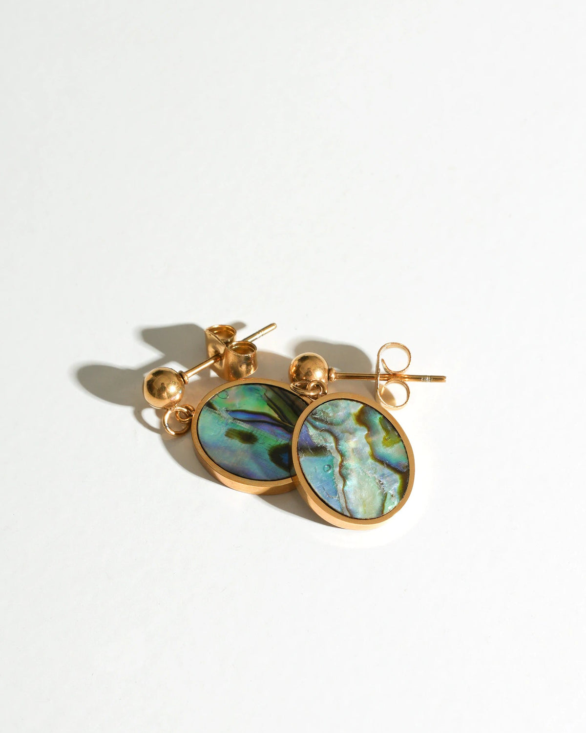 Tidal Stone Stud Earrings with round iridescent stones laid flat
