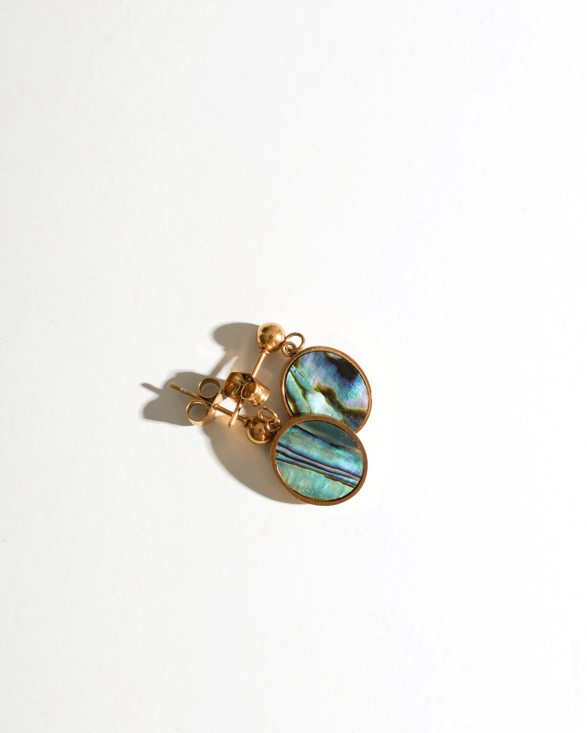 Tidal Stone Stud Earrings in gold settings on a white background