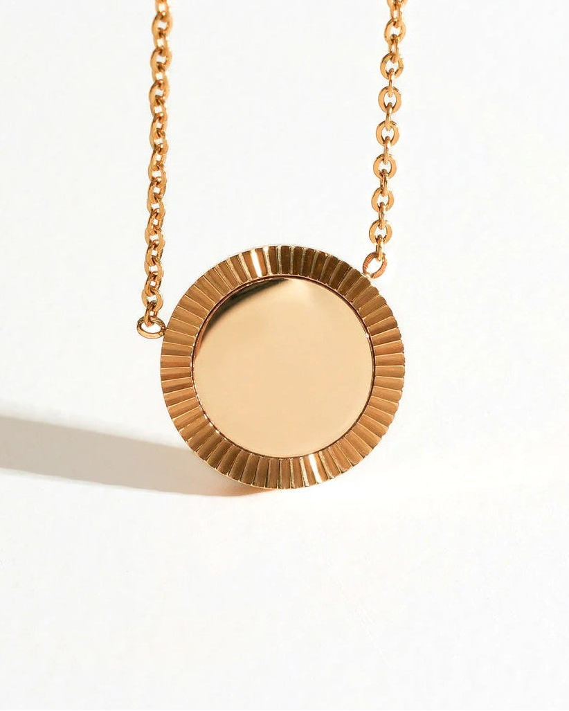Close-up of Gold Reflection Pendant Necklace with a round mirror pendant