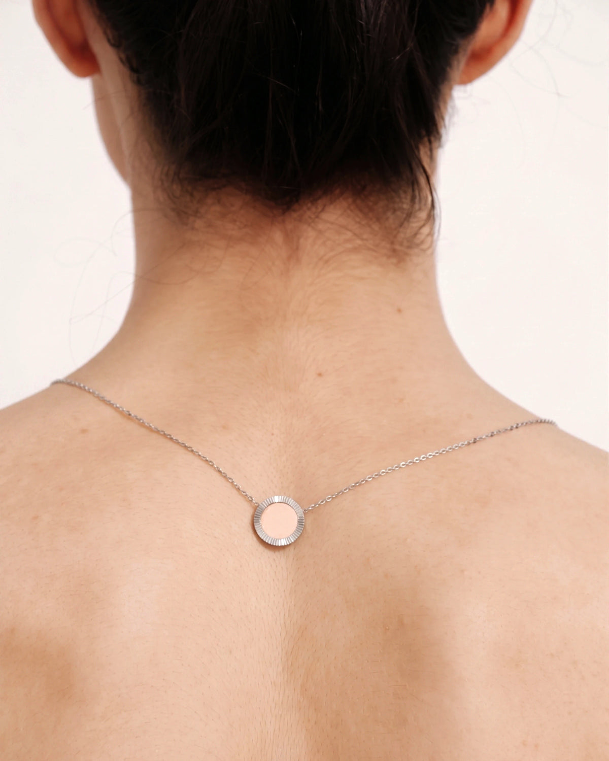 Back view of model wearing the Silver Reflection Pendant Necklace