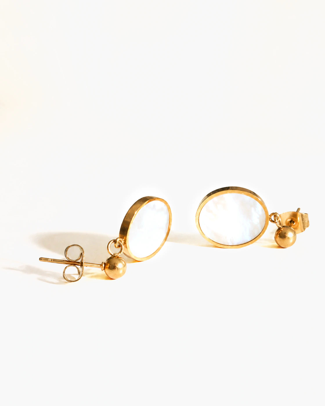 Tide Stone Stud Earrings in gold settings on a white background
