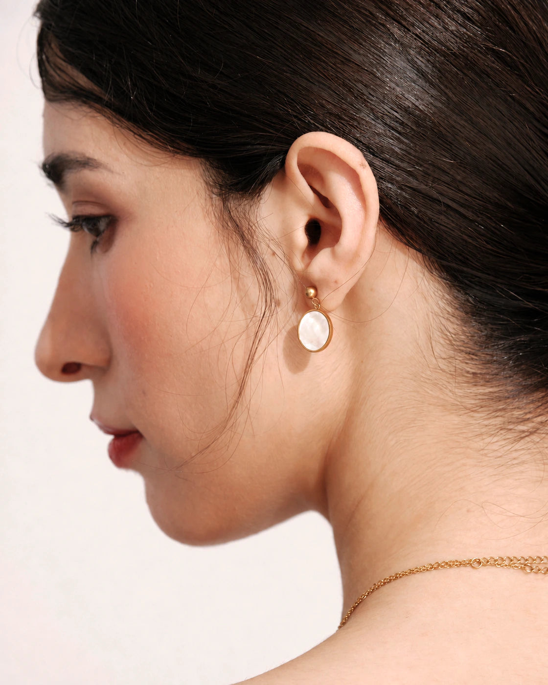 Profile view of a model wearing a Tide Stone Stud Earring