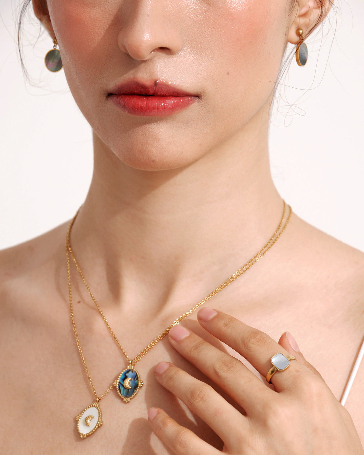 Model wearing the Tide Stone Pendant Necklace with a white top