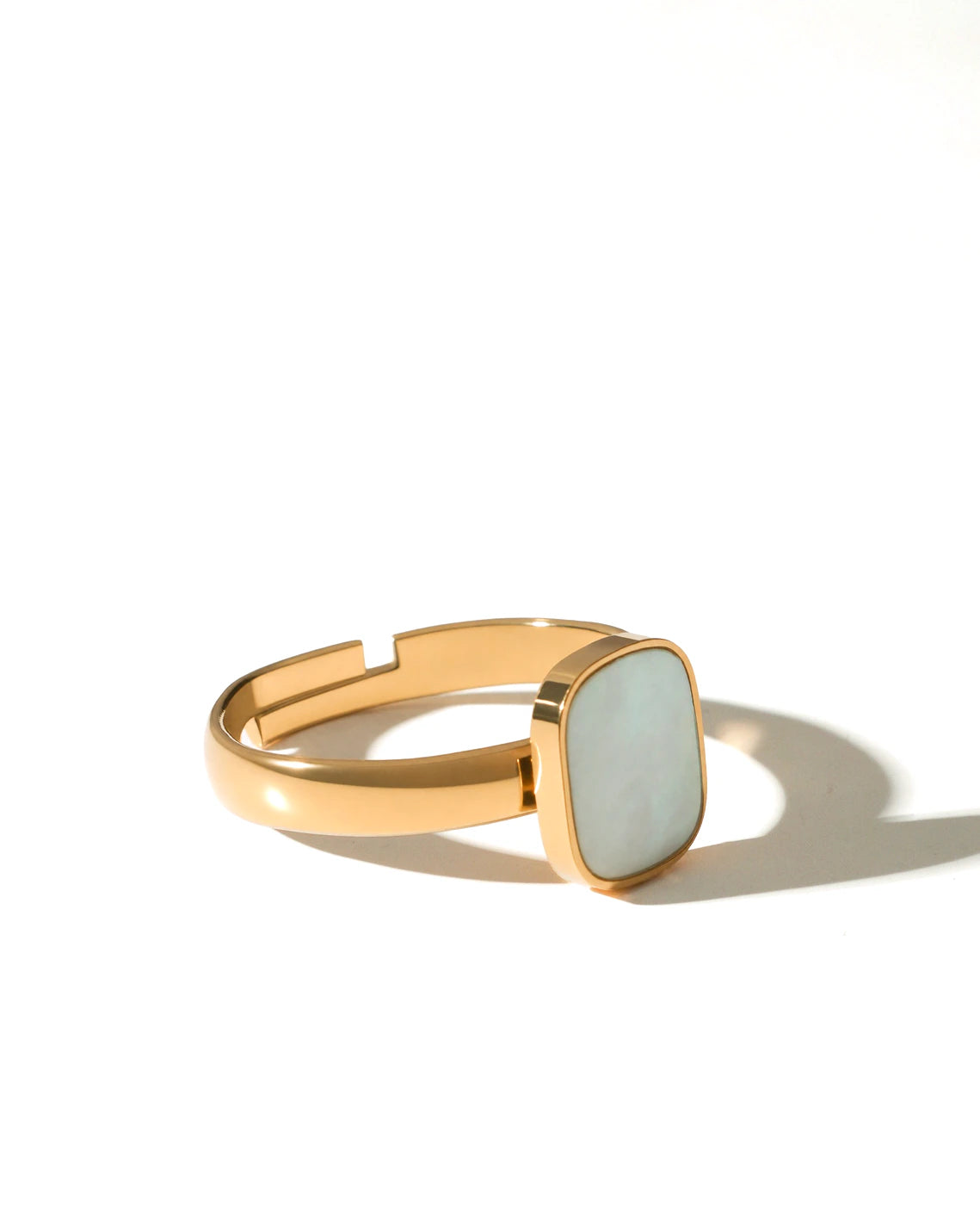 Side view of the adjustable Tide Stone Ring on a cream background
