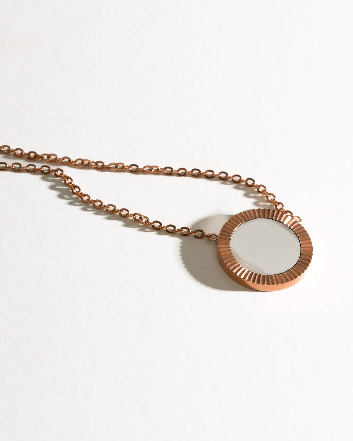 Close-up of Rose Reflection Pendant Necklace with a round mirror pendant