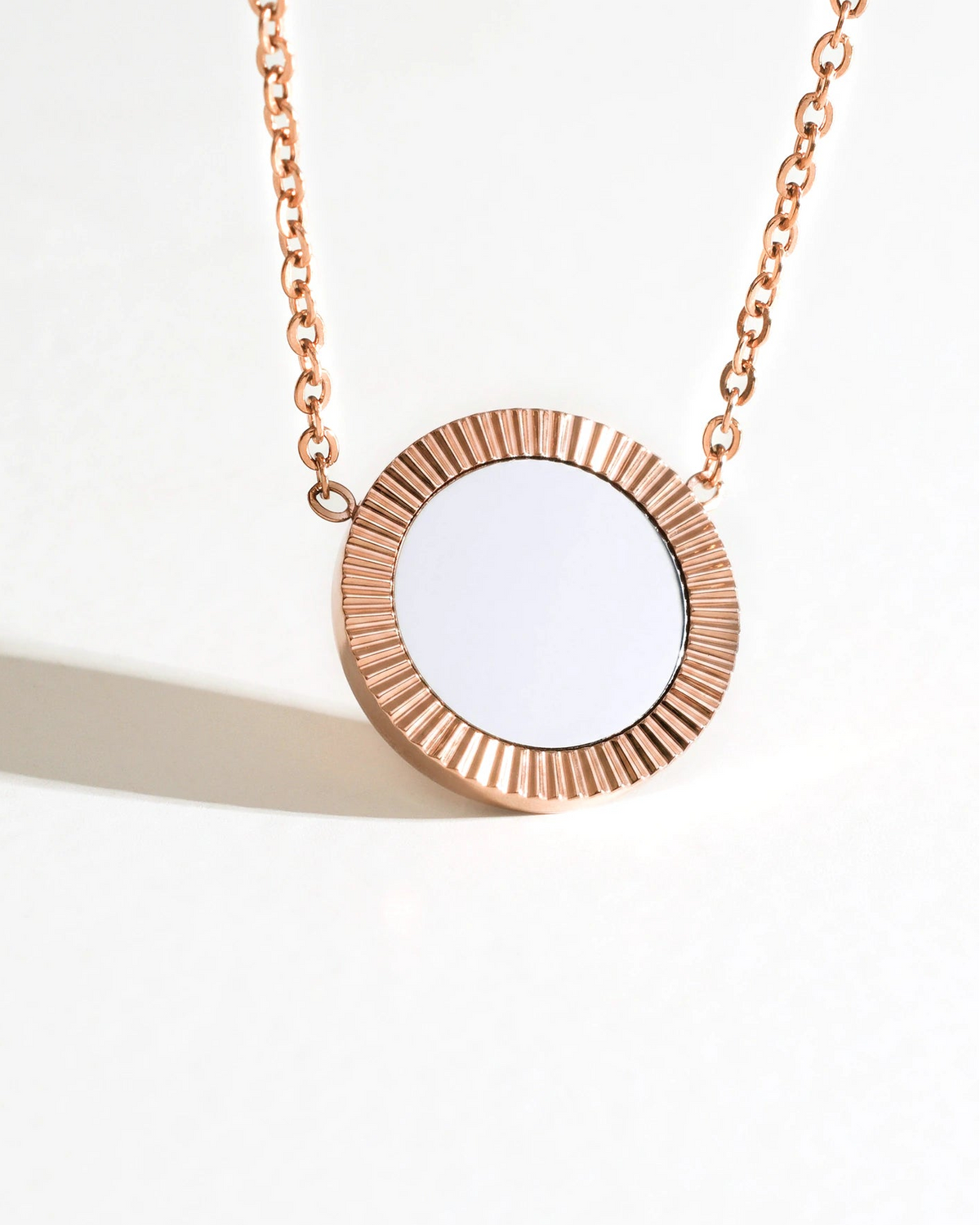 Front view of Rose Reflection Pendant Necklace on a cream background