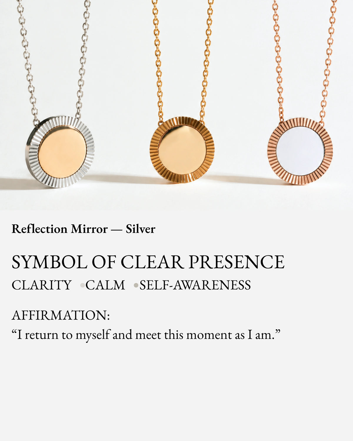 Silver Reflection pendant shown with gold and rose-gold Reflection necklaces on a meaning card