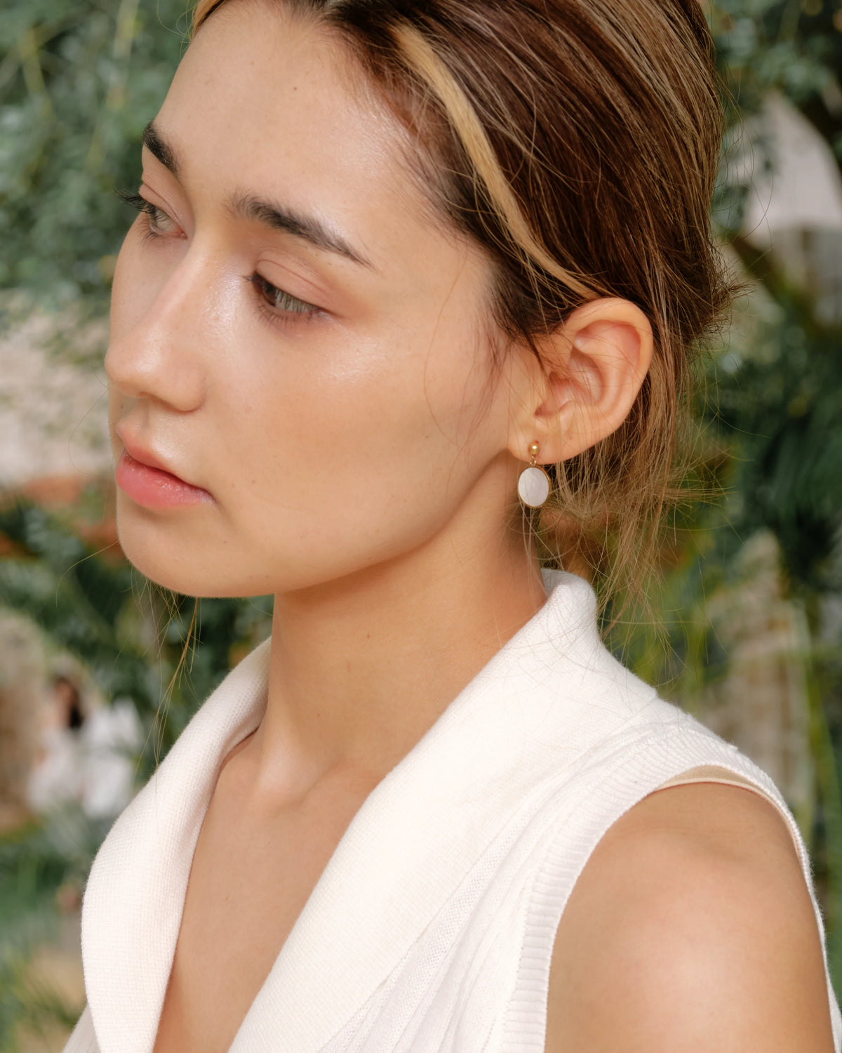 Model wearing Tide Stone Stud Earrings outdoors