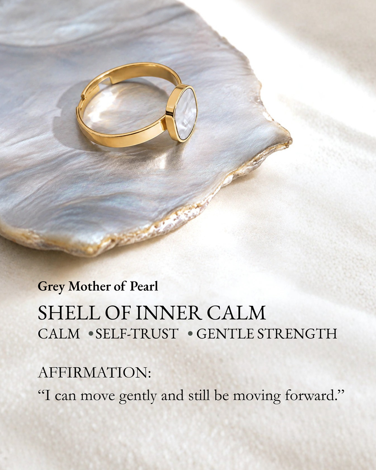 Mist Tide Ring resting on grey mother-of-pearl shell with a meaning card