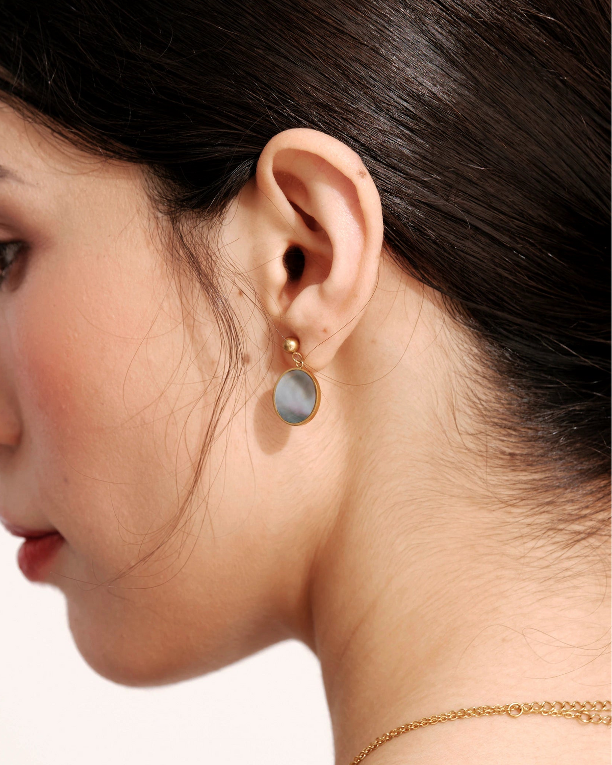Side view of a model wearing a Mist Tide Stud Earring