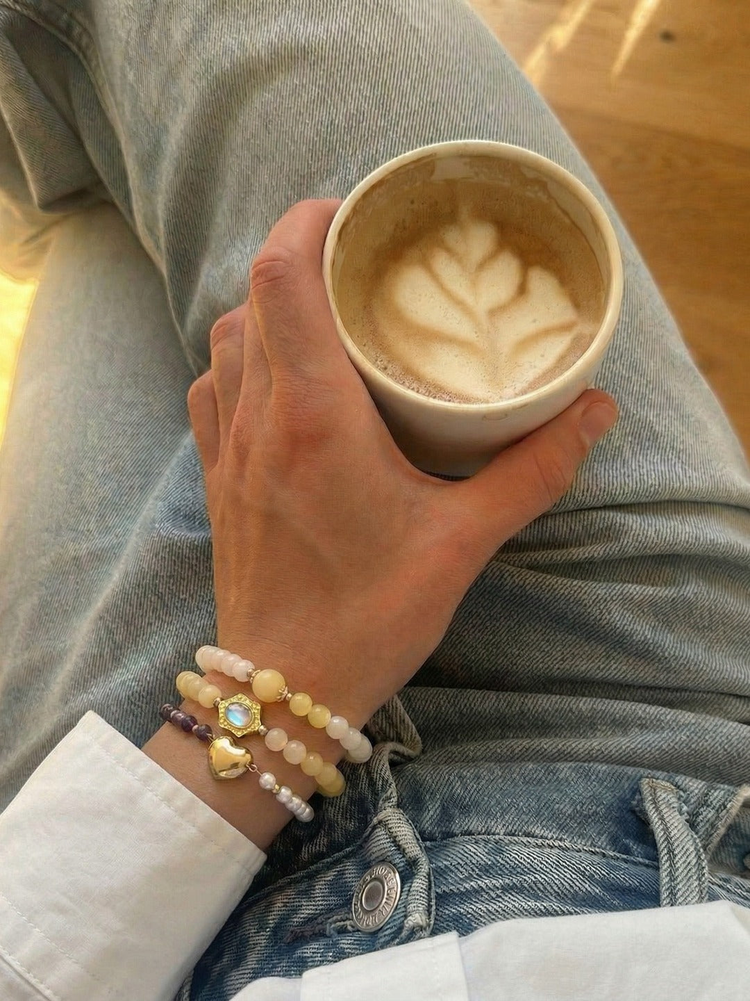 Bracelets worn in a quiet coffee moment during the day.